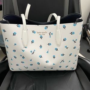 Kate Spade white bag with blue & black flower detailing and white wristlet